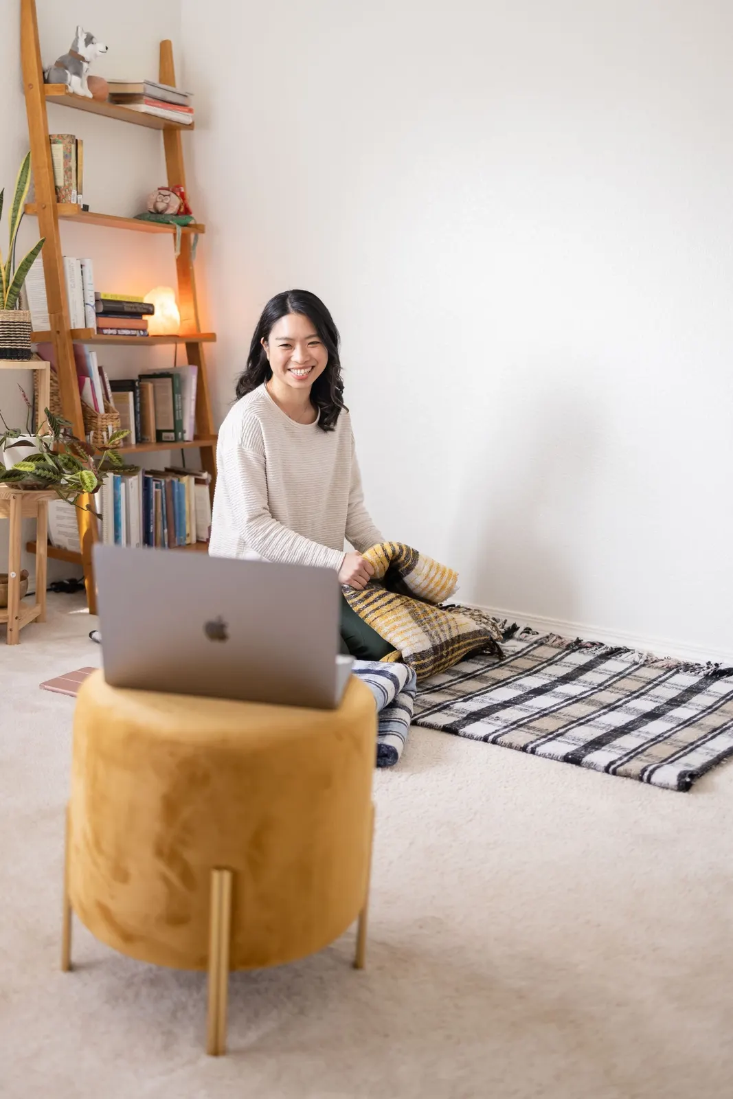 Elaine practicing yoga at home with her laptop
